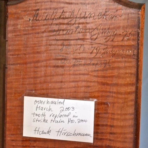 An early 19th century history of clock repairs is engraved inside the door!